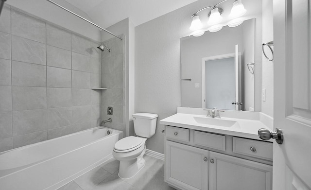 full bathroom with tile patterned floors, toilet, vanity, and tiled shower / bath