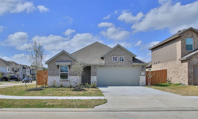 view of front of home featuring a garage and a front yard