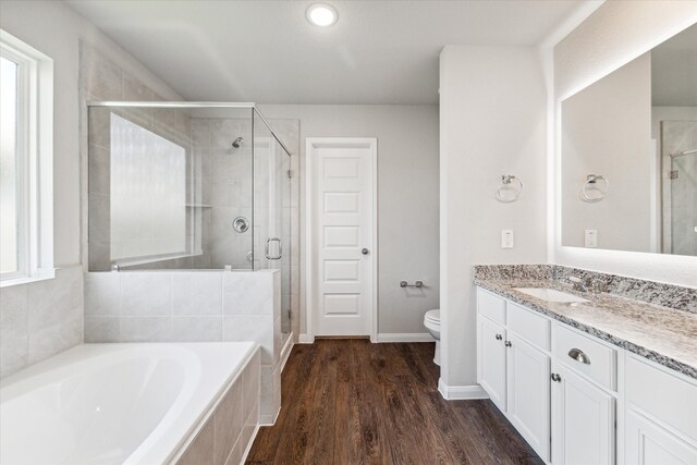 full bathroom featuring wood-type flooring, vanity, toilet, and independent shower and bath