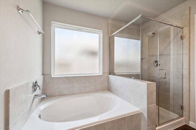 bathroom with plus walk in shower and a wealth of natural light