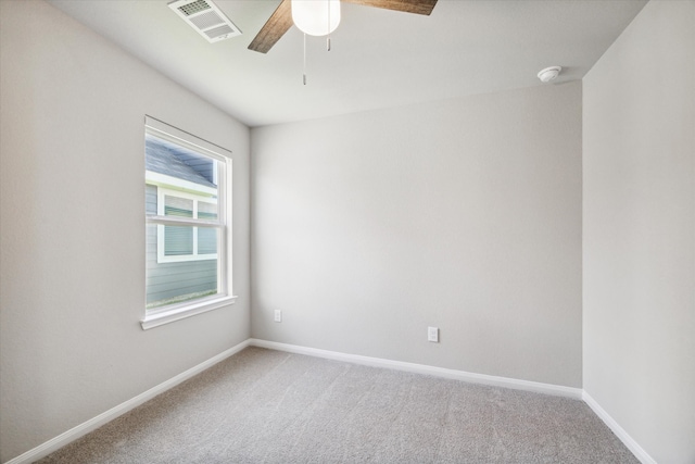 carpeted spare room featuring ceiling fan