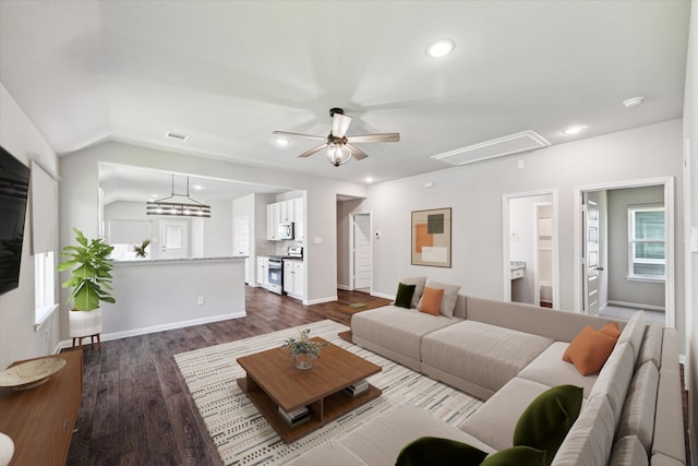 living room with dark hardwood / wood-style flooring, vaulted ceiling, and ceiling fan