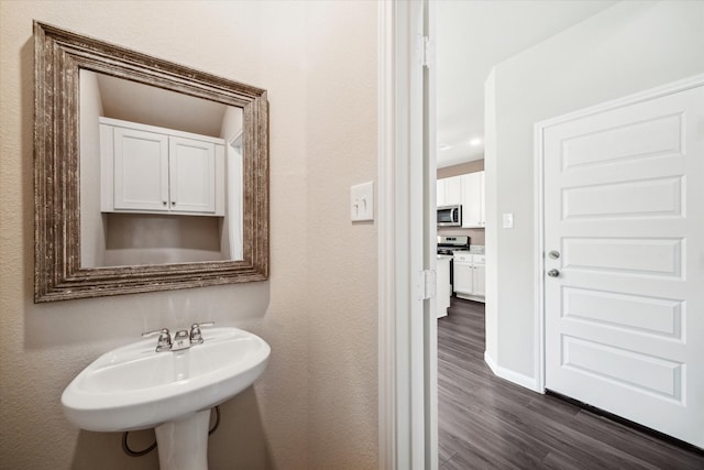 bathroom with hardwood / wood-style flooring and sink