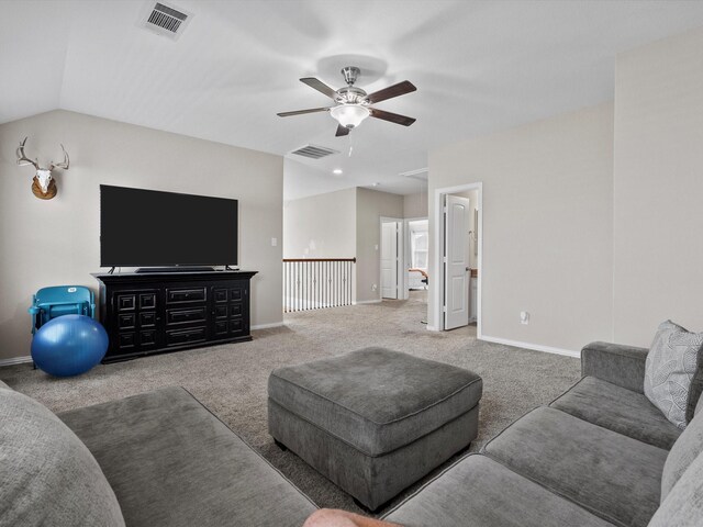 carpeted living room with ceiling fan and lofted ceiling