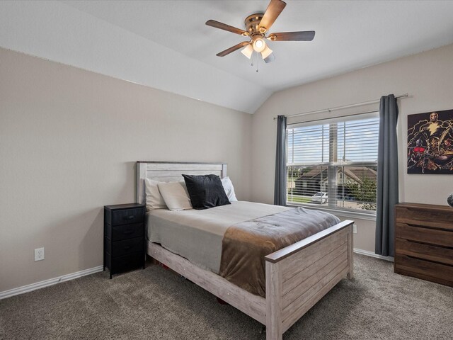 bedroom featuring ceiling fan, dark carpet, and lofted ceiling