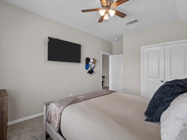 carpeted bedroom with a closet and ceiling fan