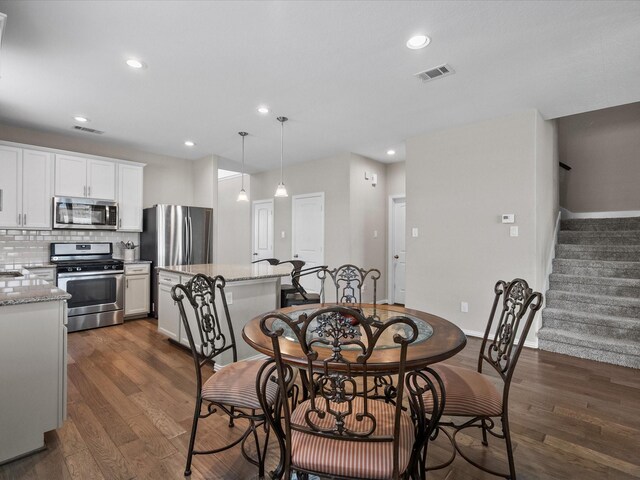 dining area with dark hardwood / wood-style floors