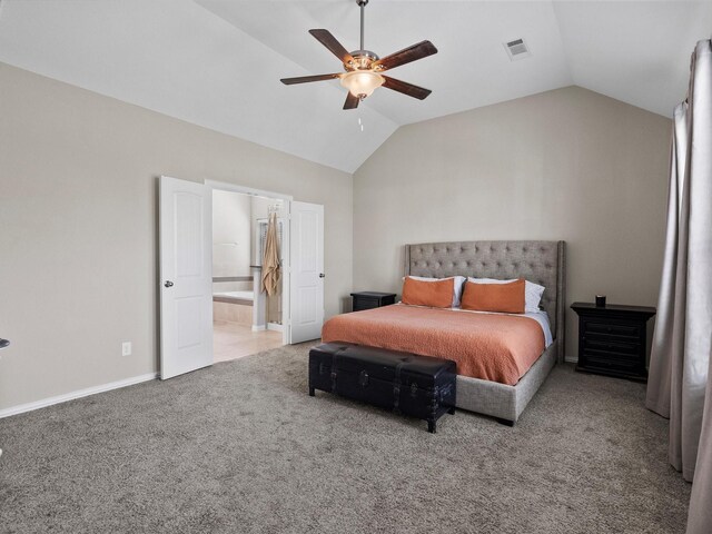 bedroom featuring carpet flooring, connected bathroom, vaulted ceiling, and ceiling fan