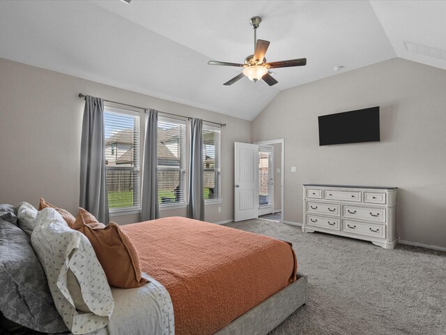 carpeted bedroom with ceiling fan and vaulted ceiling