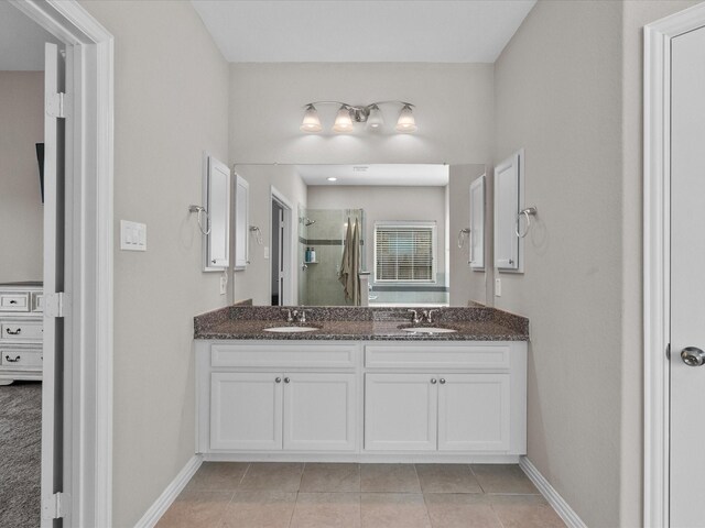 bathroom with vanity, walk in shower, and tile patterned floors