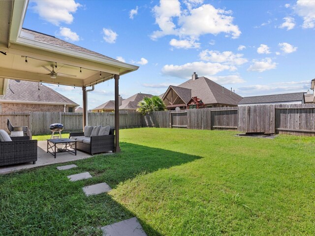 view of yard with ceiling fan, a patio area, and an outdoor hangout area