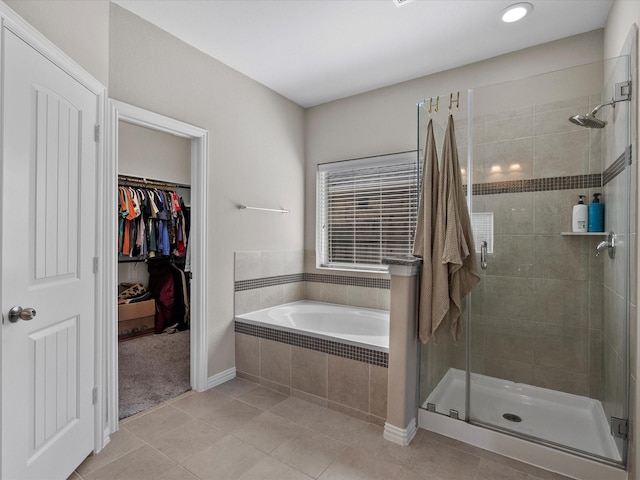 bathroom featuring tile patterned floors and shower with separate bathtub