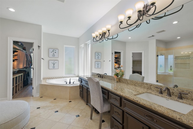 bathroom featuring independent shower and bath, tile patterned flooring, and vanity