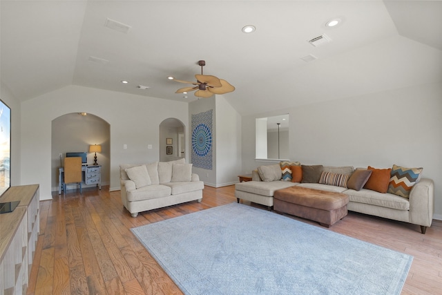 living room with light hardwood / wood-style flooring, lofted ceiling, and ceiling fan