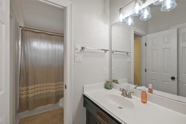 bathroom featuring vanity, tile patterned flooring, toilet, and curtained shower