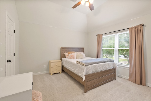 bedroom featuring lofted ceiling, ceiling fan, and light colored carpet