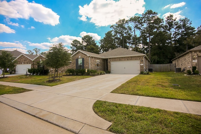 view of front of property with a garage, a front lawn, and central AC