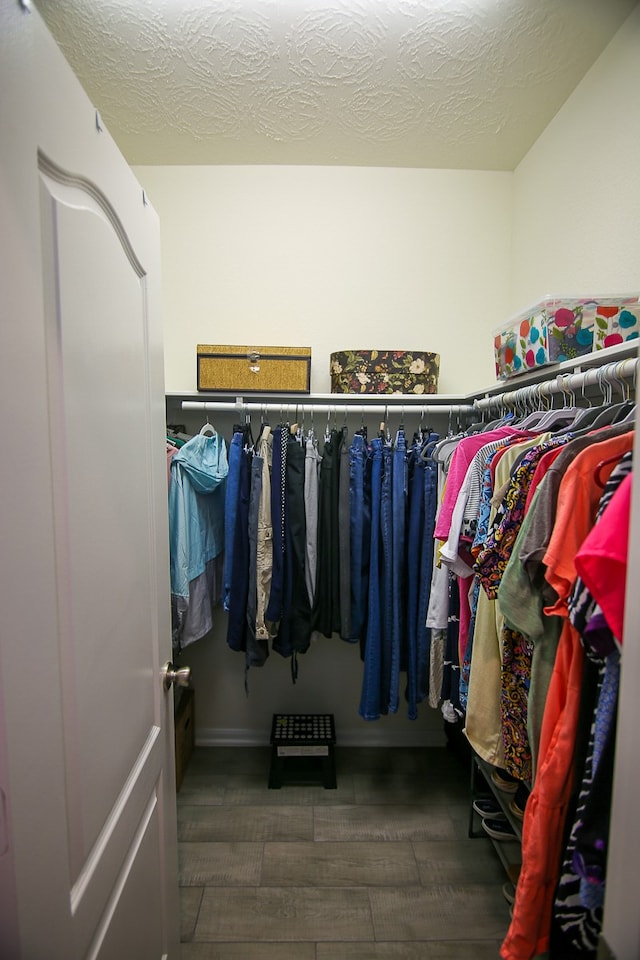 spacious closet with dark hardwood / wood-style floors