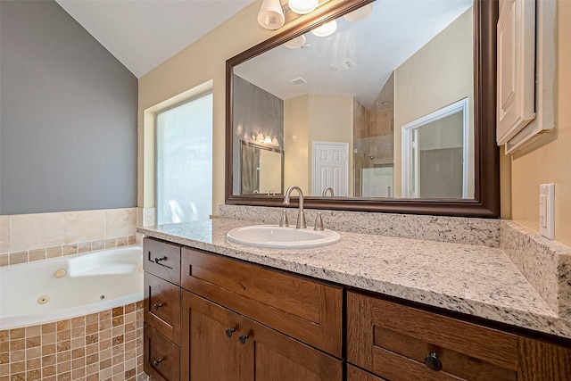 bathroom featuring separate shower and tub, lofted ceiling, and vanity