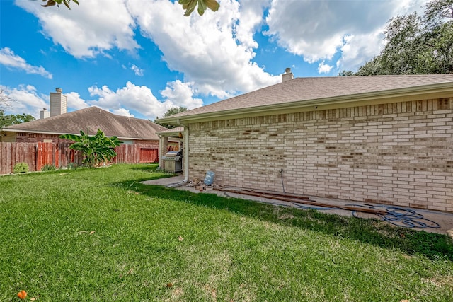 view of side of home featuring a yard