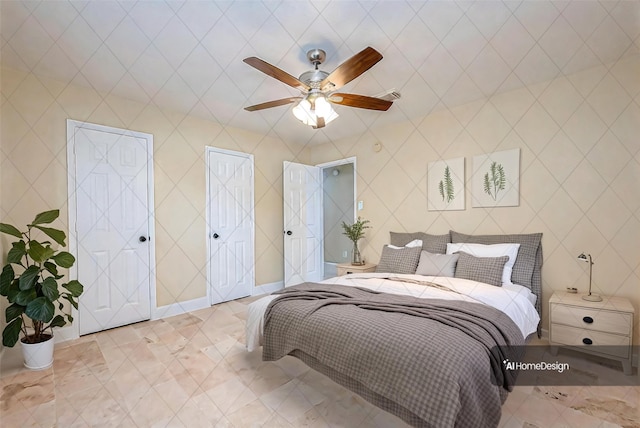 bedroom with multiple closets and ceiling fan