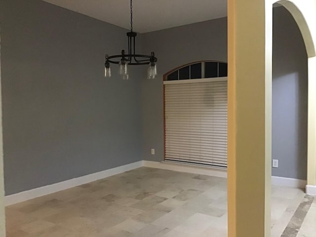 unfurnished dining area with an inviting chandelier