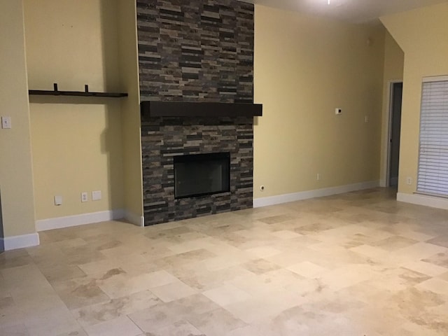 unfurnished living room with a stone fireplace