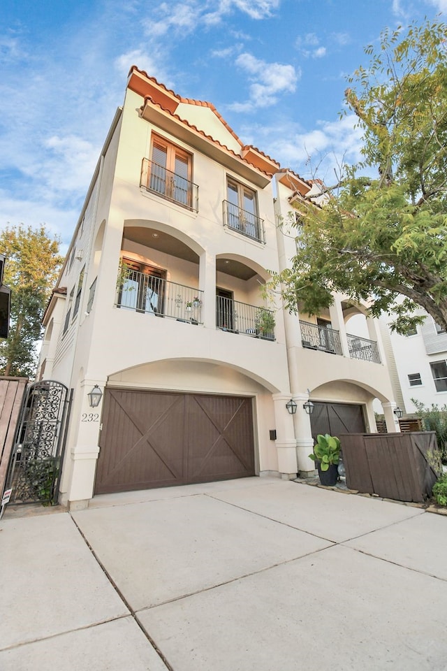 mediterranean / spanish home with a balcony and a garage