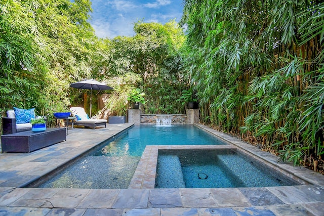 view of swimming pool featuring an in ground hot tub and a patio area