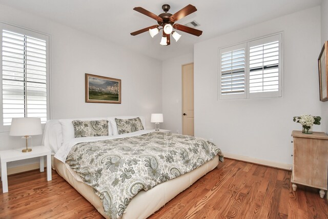 bedroom featuring light hardwood / wood-style flooring and ceiling fan