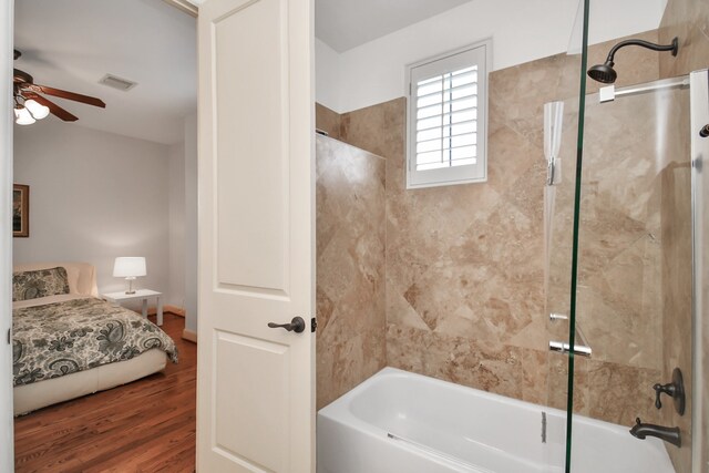 bathroom featuring hardwood / wood-style floors, combined bath / shower with glass door, and ceiling fan