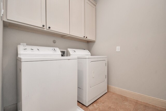 laundry room featuring cabinets and separate washer and dryer