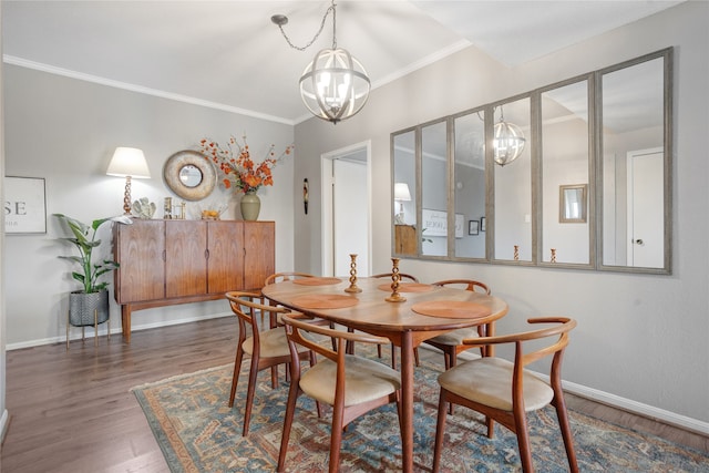 dining area with crown molding, dark hardwood / wood-style floors, and a chandelier