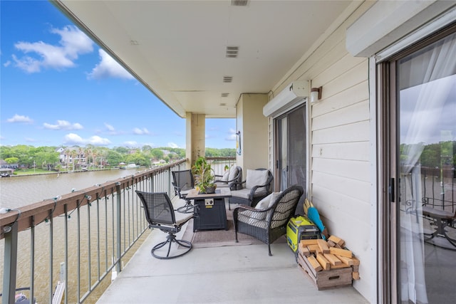 balcony featuring outdoor lounge area and a water view