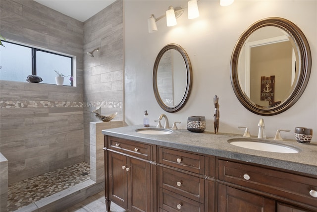 bathroom featuring vanity and a tile shower