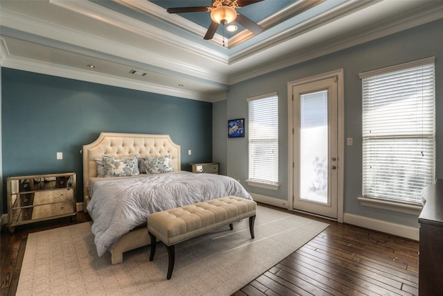 bedroom featuring ceiling fan, dark hardwood / wood-style flooring, a tray ceiling, access to outside, and ornamental molding