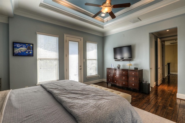 bedroom with dark hardwood / wood-style flooring, a raised ceiling, ceiling fan, and crown molding