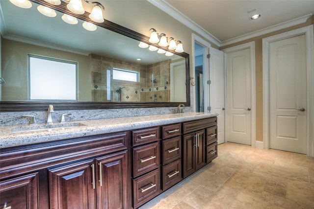 bathroom featuring a tile shower, vanity, and ornamental molding