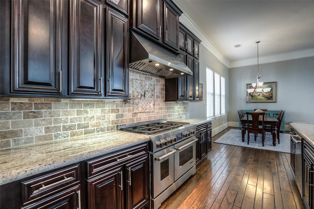 kitchen with backsplash, dark wood-type flooring, range with two ovens, hanging light fixtures, and ornamental molding