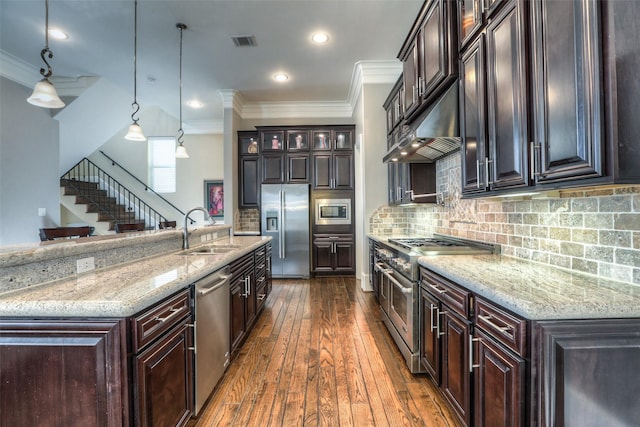 kitchen featuring sink, hanging light fixtures, stainless steel appliances, dark hardwood / wood-style flooring, and dark brown cabinets