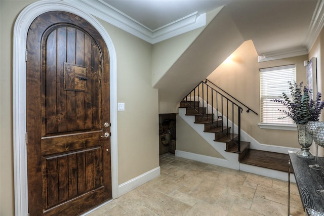 entryway featuring crown molding