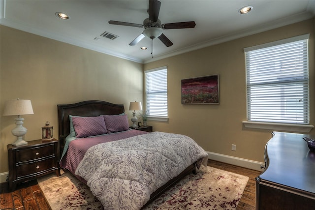 bedroom featuring ceiling fan, dark hardwood / wood-style flooring, and multiple windows