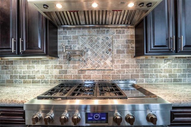 kitchen with stainless steel range, tasteful backsplash, and wall chimney range hood