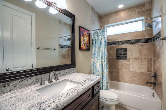 full bathroom with shower / bath combo with shower curtain, vanity, and toilet