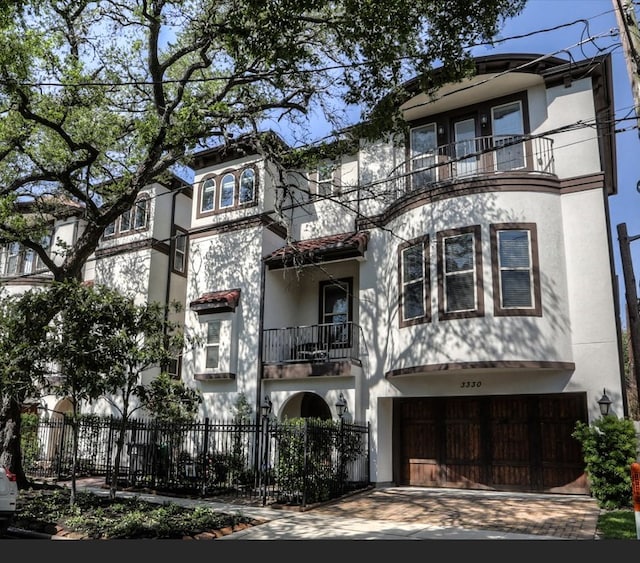 view of front of house with a balcony and a garage