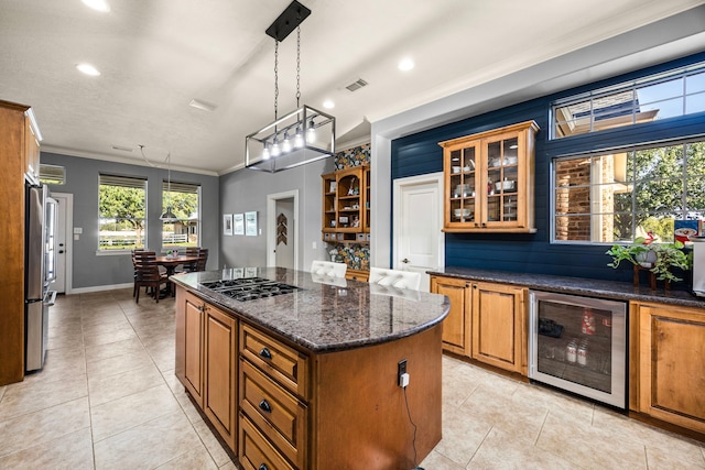 kitchen featuring pendant lighting, crown molding, appliances with stainless steel finishes, a kitchen island, and beverage cooler