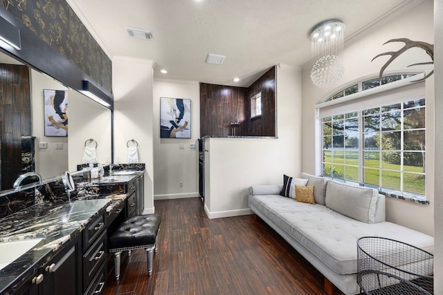 interior space featuring dark hardwood / wood-style floors, crown molding, and sink