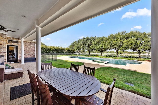 view of patio / terrace featuring a fenced in pool and ceiling fan