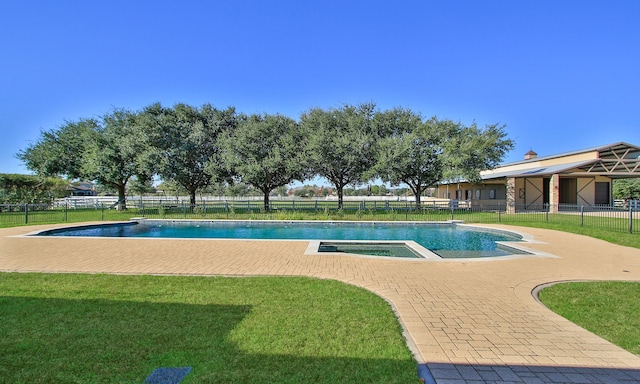 view of swimming pool featuring a yard and an in ground hot tub