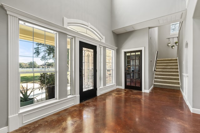 entryway with a healthy amount of sunlight and a towering ceiling